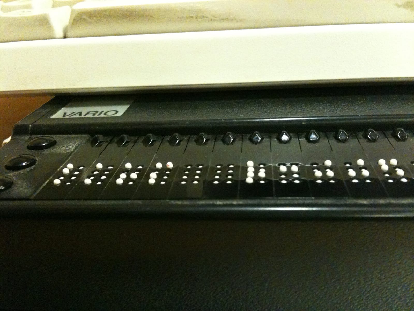 Close-up of a refreshable Braille display with raised pins forming Braille characters