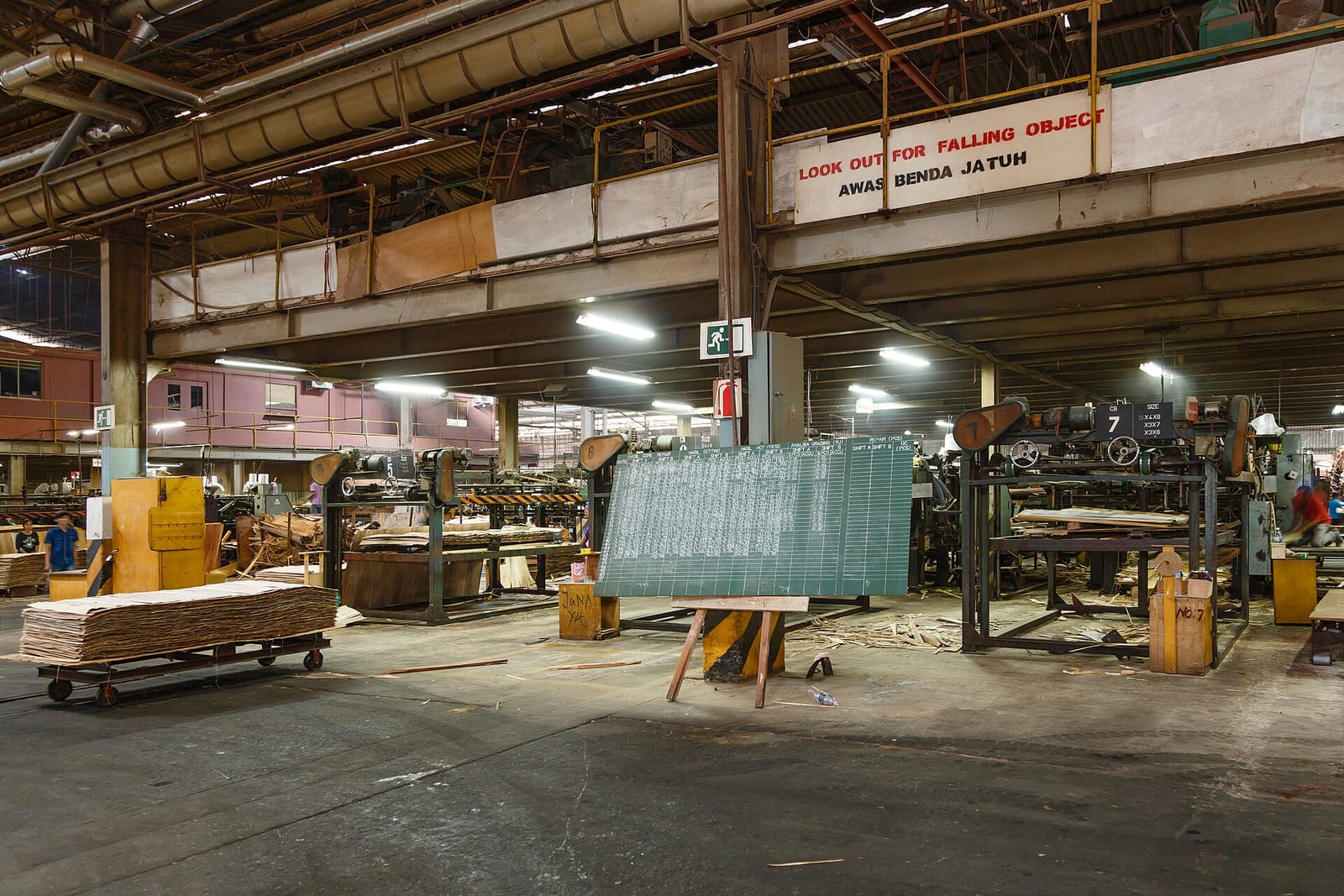 The factory floor of a plywood mill in Sandakan, Malaysia, with a board tracking shift productivity