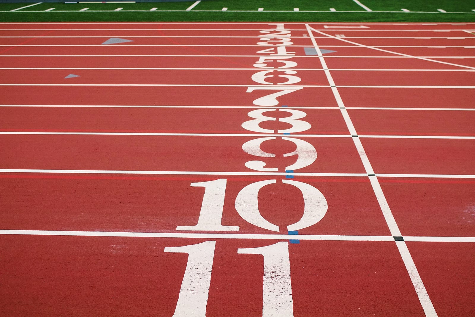 Numbered lanes at the start line of a running track