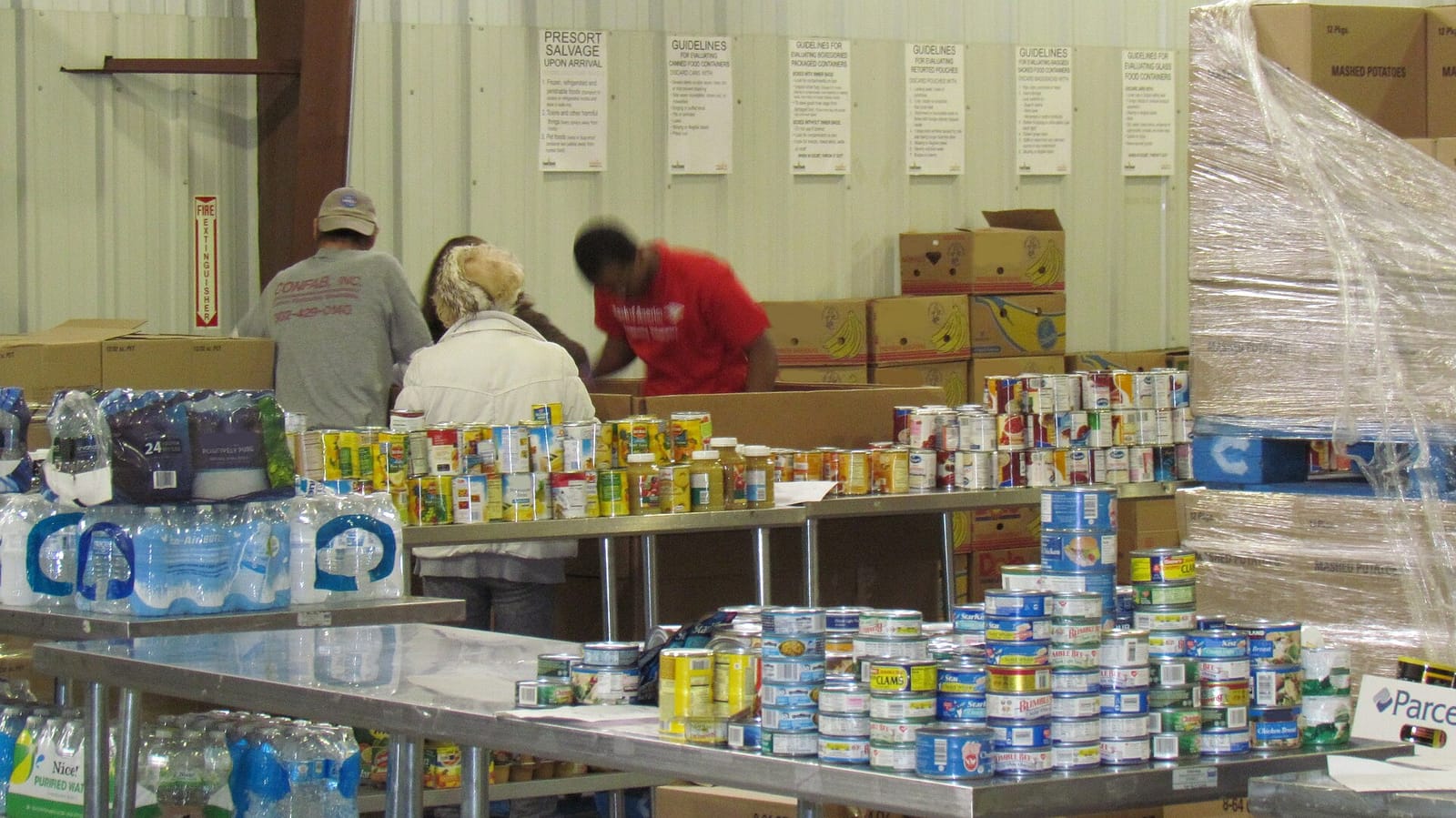 Volunteers sorting donated canned food at the Food Bank of Delaware