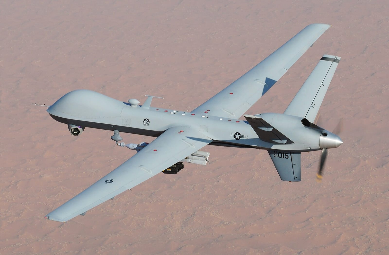 An MQ-9 Reaper unmanned aerial vehicle in flight over desert