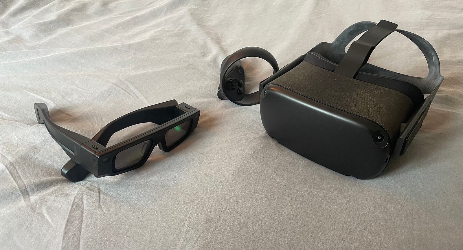 Snap's 2024 Spectacles AR glasses, the developer predecessor of Specs, next to a Meta Quest VR headset