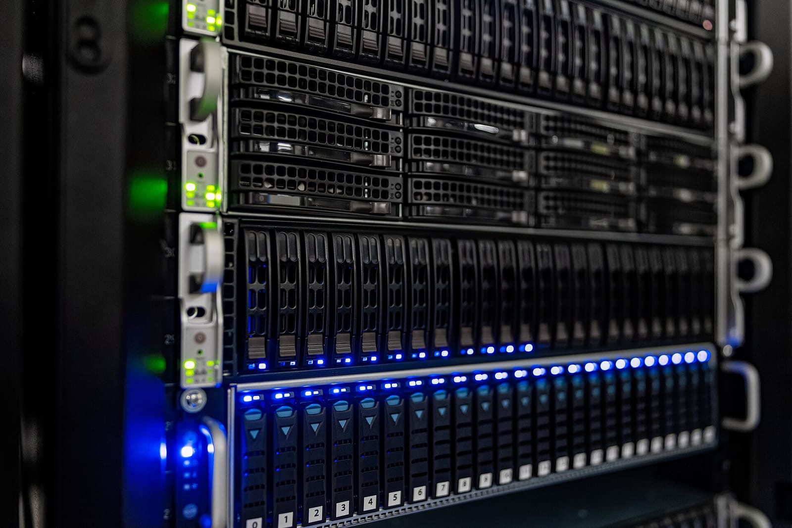 Close-up of rack-mounted servers with blue status lights in a server room