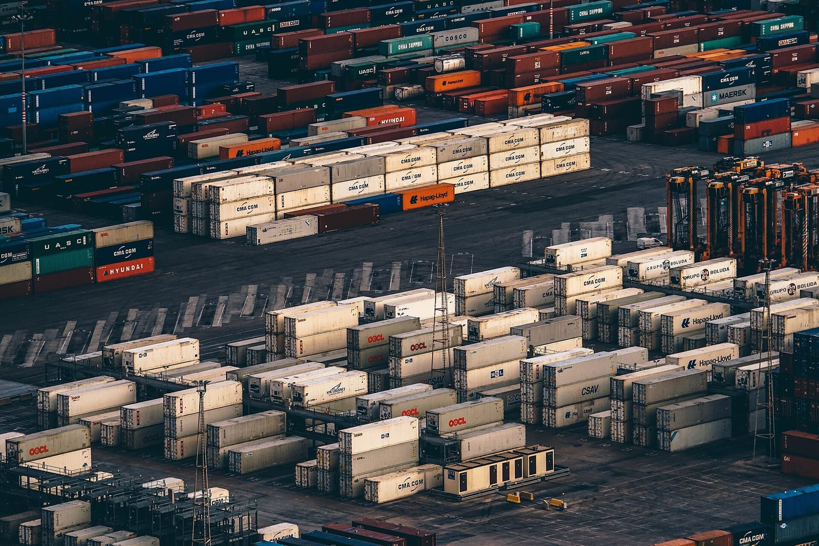 Rows of stacked shipping containers at a port terminal