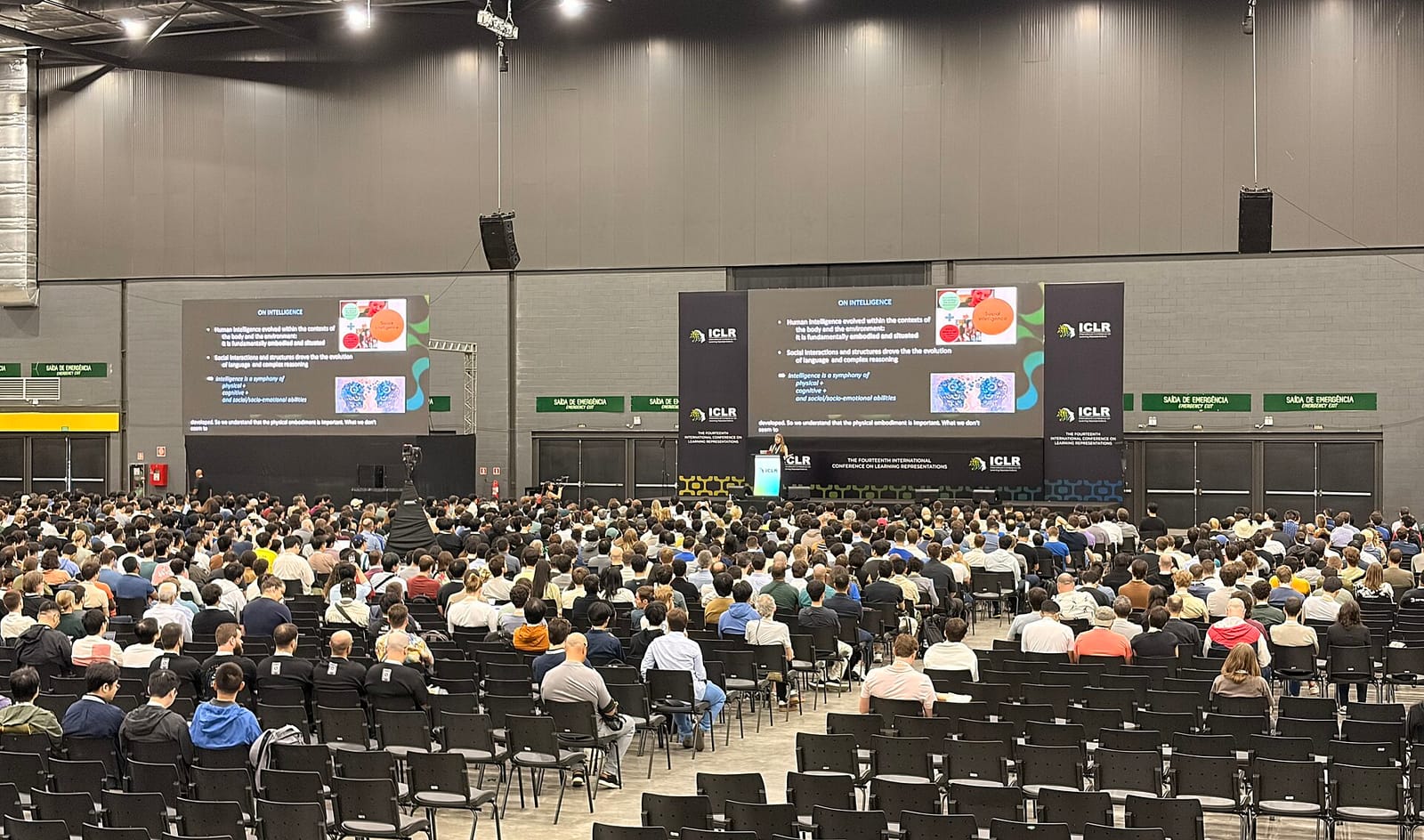 A large audience in front of the main stage at the ICLR 2026 conference