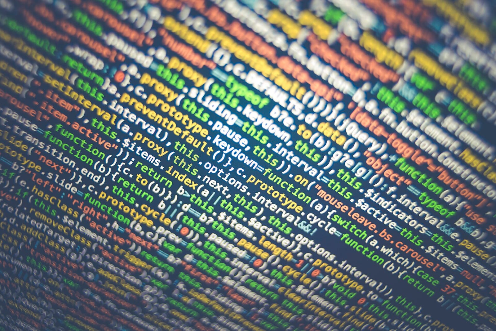 Lines of colourful JavaScript code filling a screen at an angle