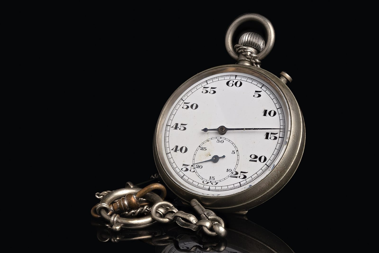 A mechanical stopwatch on a black background