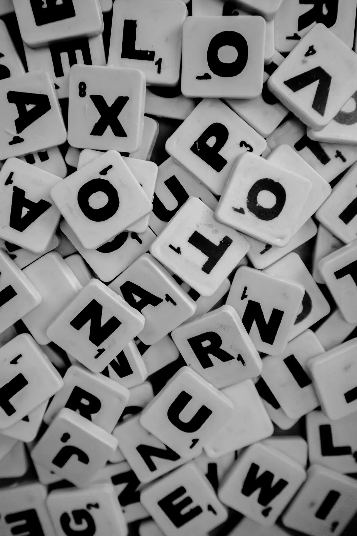 A pile of letter tiles in black and white