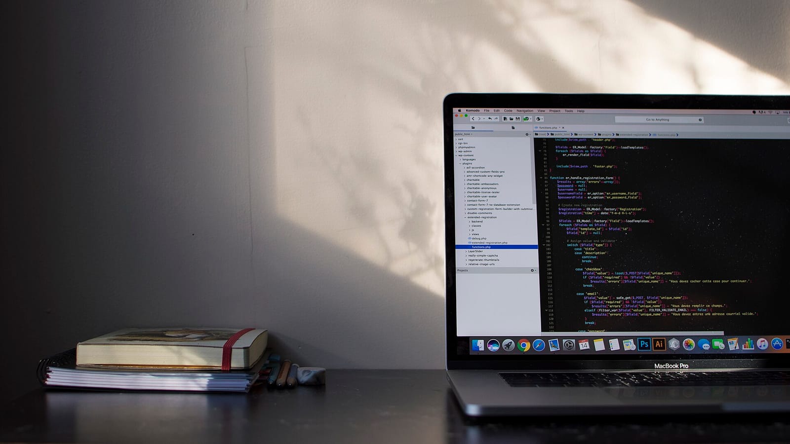 A laptop showing a code editor on a desk in soft daylight