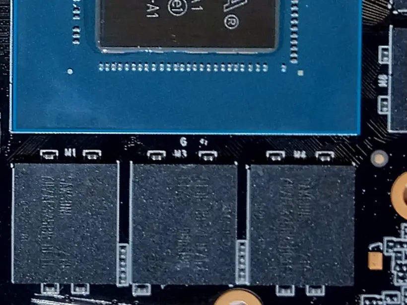 Close-up of a graphics card circuit board showing the GPU chip edge and a row of black GDDR6 memory chips beside it