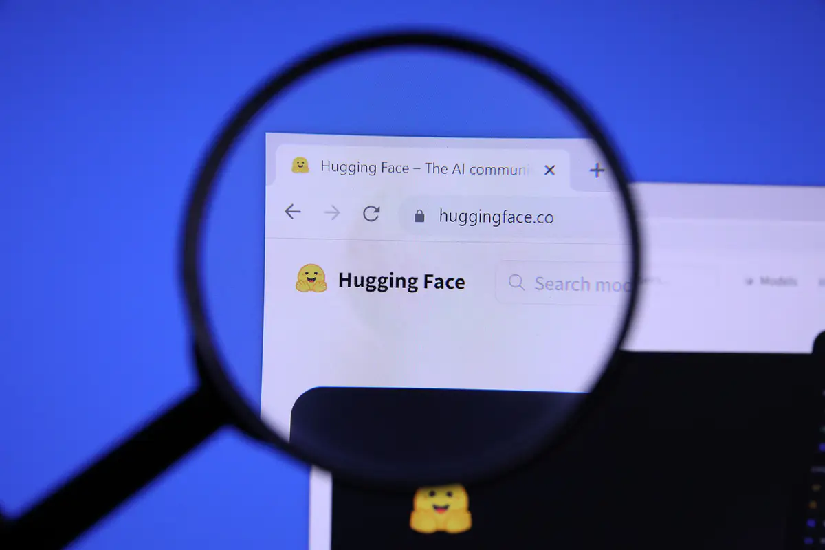The Hugging Face website homepage seen through a magnifying glass