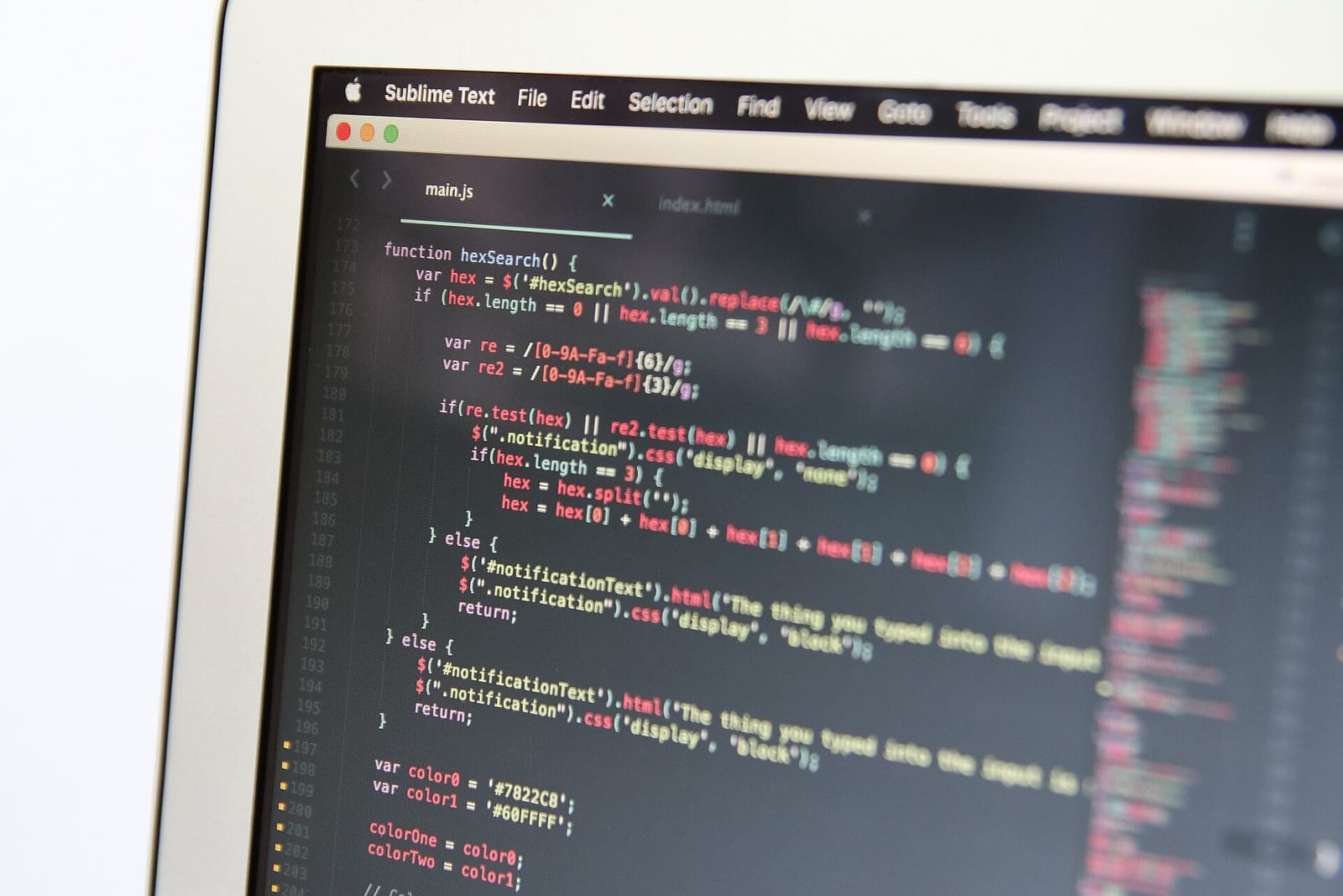 Close-up of JavaScript code in a text editor on a laptop screen