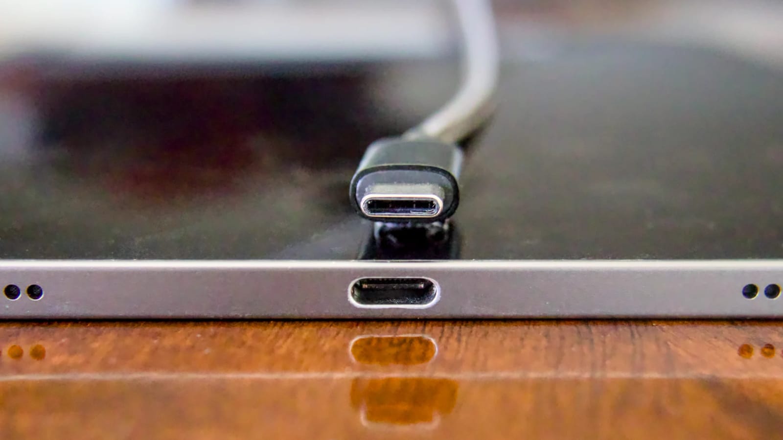 USB-C cable connector next to a USB-C port on a device