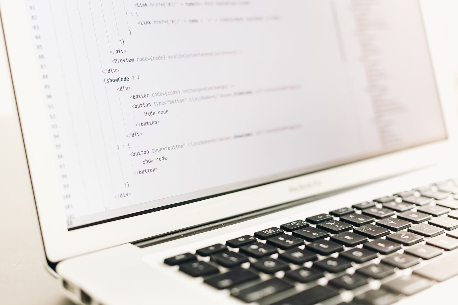 Laptop screen showing lines of code, seen at an angle