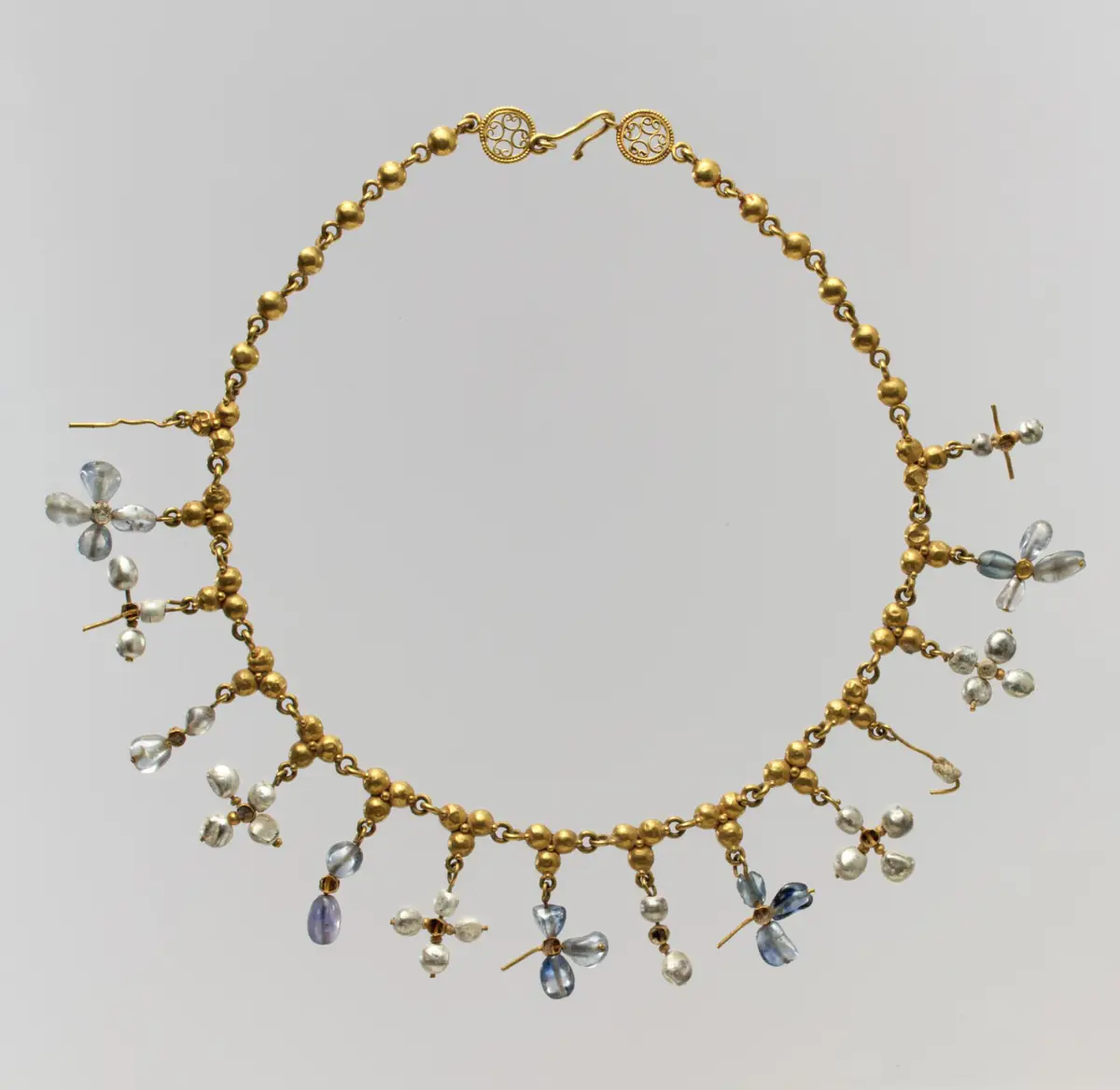 Historic necklace with pendants, shown as an example of jewelry worn on the chest; not the Nirva device