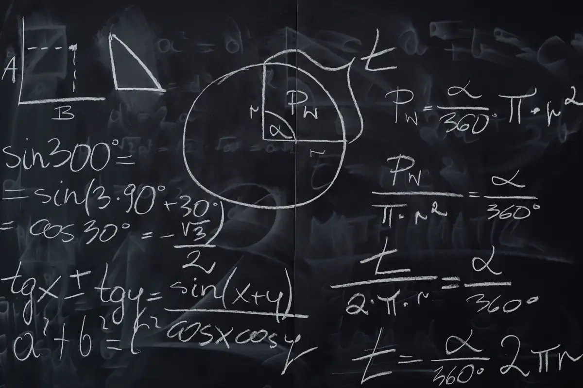 Trigonometric equations and geometric diagrams drawn on a classroom blackboard