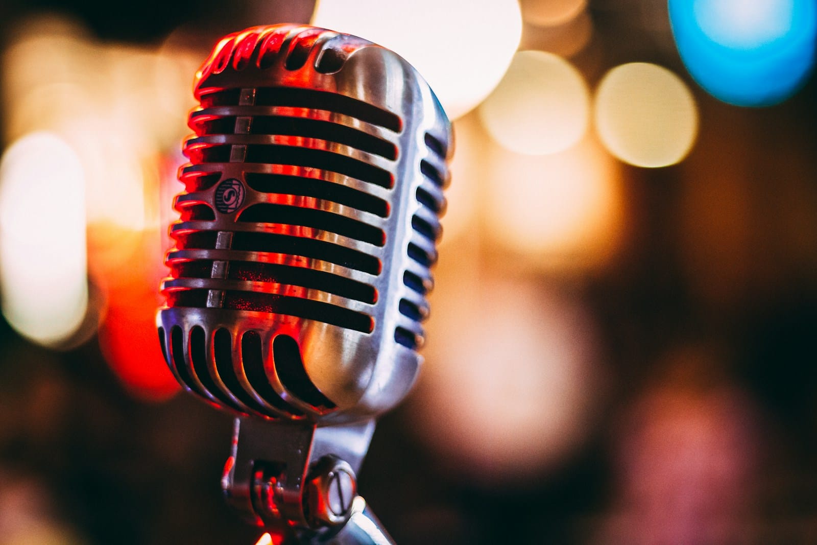 Condenser microphone against a softly blurred background of lights