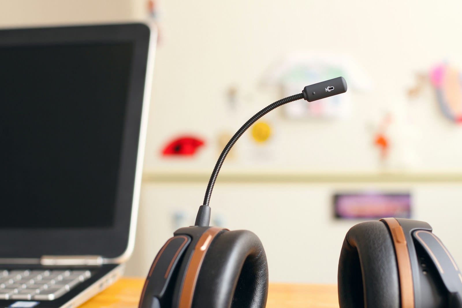 Headset lying next to a laptop computer
